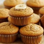 Freshly baked cottage cheese banana muffins on a cooling rack with ingredients
